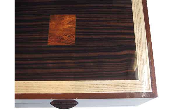 Macassar ebony with bloodwood burl inlay framed in ash and mahogany box top - close up